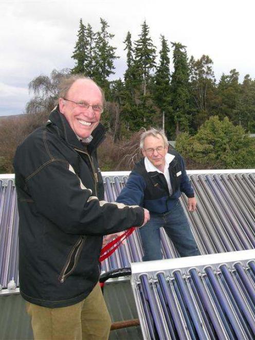 Queenstown Lakes Mayor Clive Geddes tries to cut a ribbon to a new solar heating initiative...