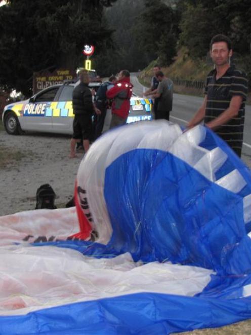 Queenstown police take statements on the edge of Lake Wakatipu as one of 30 paraglider pilots...