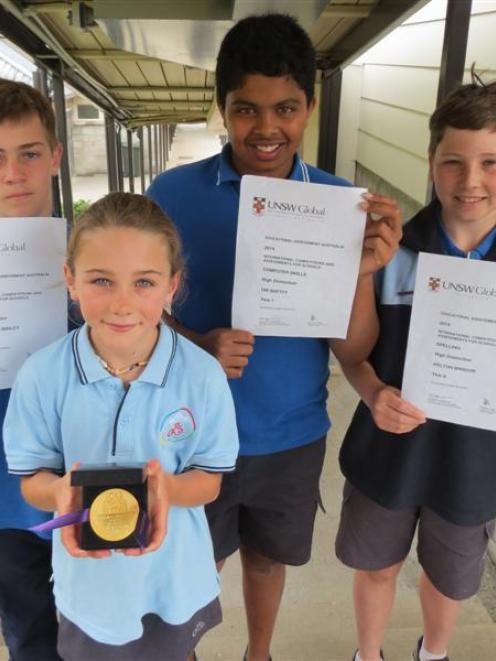 Queenstown Primary School pupil Sammy Fookes (9), front, with her International Competitions and...