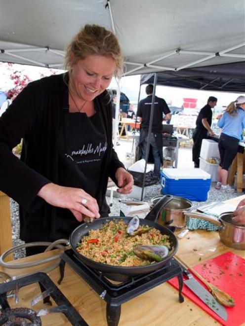 Queenstown's Lucy Thompson prepares paella with Zamora spicy sausages and mussels during a heat...