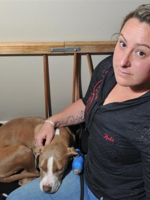 Ra McRoberts in her Dunedin home with her sick dog Sapphire. Photo by Gregor Richardson.