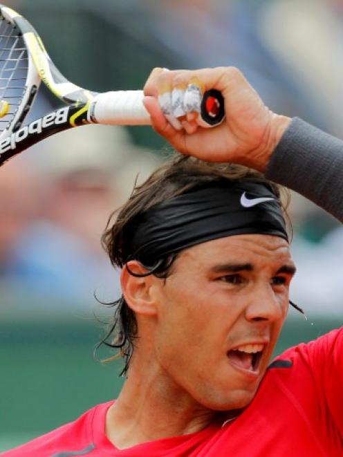 Rafael Nadal of Spain returns the ball to Denis Istomin of Uzbekistan during their match at the...