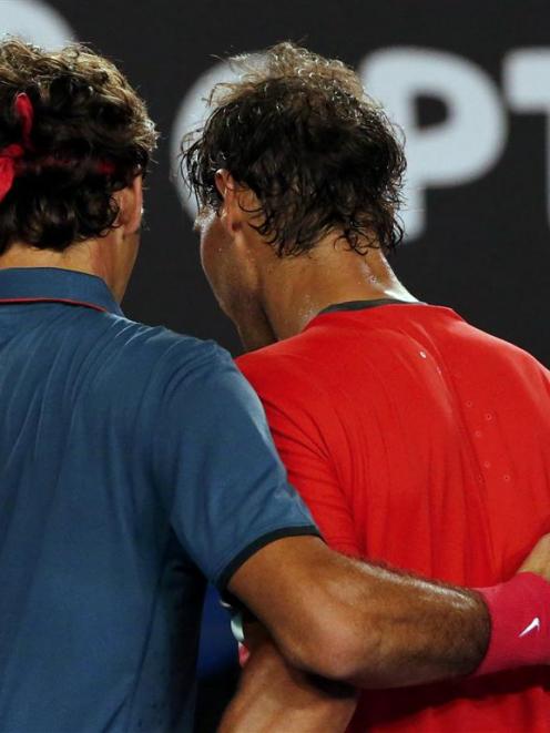 Rafael Nadal (right) consoles Roger Federer at the net.   REUTERS/Petar Kujundzic
