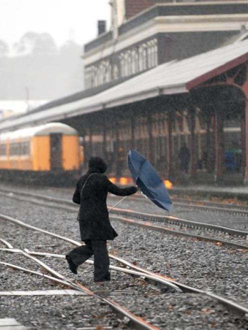 A pedestrian cuts across the railway lines next to the Dunedin Railway Station yesterday. Photo...