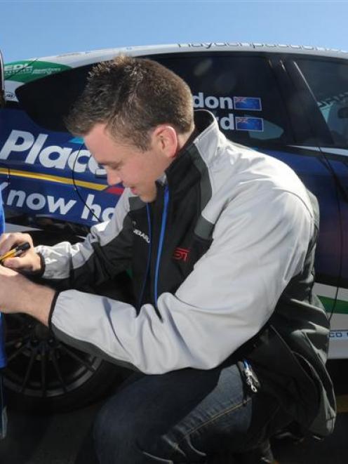 Rally driver Hayden Paddon signs the shirt of Mikko Johnston (4) during Paddon's visit to Dunedin...