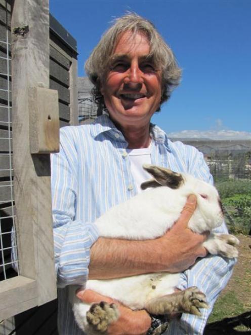 Randolph Holst, of Wanaka, with George, the breeding sire of his rabbit colony. Photo by Mark Price.