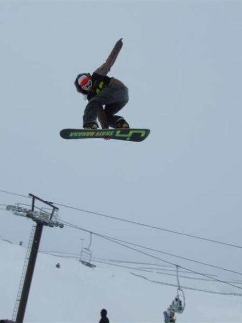 Raphael Nerz, of Switzerland, soars above a chair lift pylon at the Snowpark near Wanaka during a...
