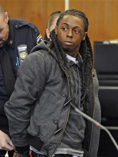 Rapper Lil Wayne is handcuffed at Manhattan criminal court in New York before starting his jail...