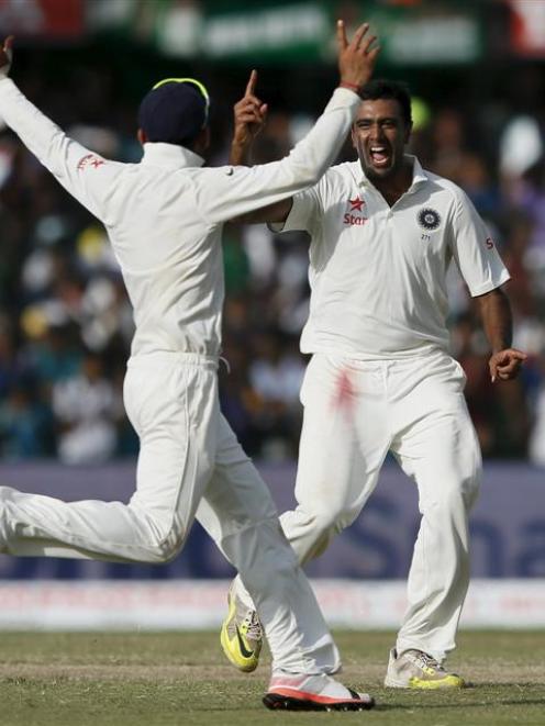 Ravi Ashwin and Indian captain Virat Kohli celebrate after a wicket.
