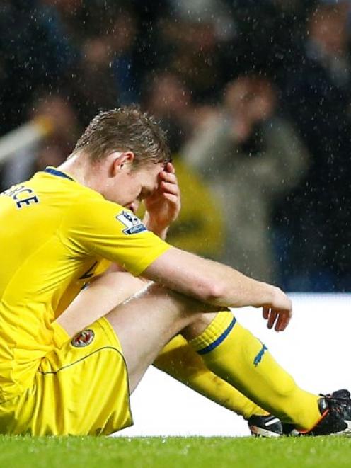 Reading's Alex Pearce reacts after his team's loss to Manchester City in their English Premier...