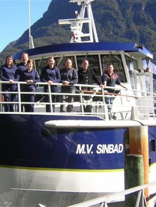 Real Journeys staff and MV Sinbad personnel stand behind the rail of the new Milford Sound cruise...