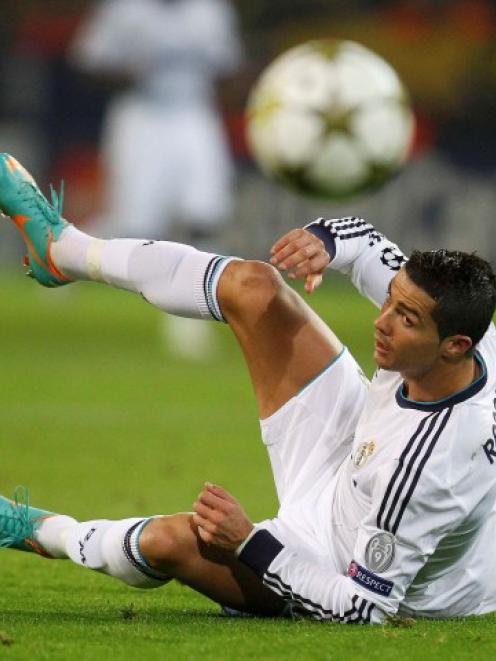 Real Madrid's Cristiano Ronaldo falls on the pitch during their Champions League Group D match...