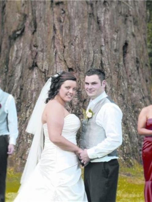 Rebecca Knight and Regan Brown with their wedding party at Mount Stuart Reserve, after their...