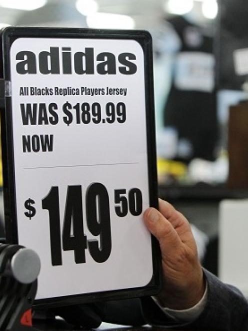 Rebel Sport Managing Director Rod Duke puts up the new price tag for the standard All Black...