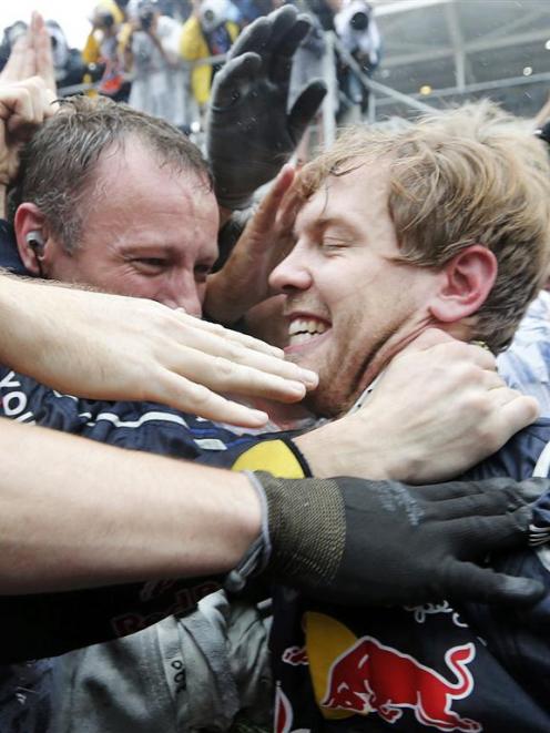 Red Bull Formula One driver Sebastian Vettel celebrates winning the world championship with his...