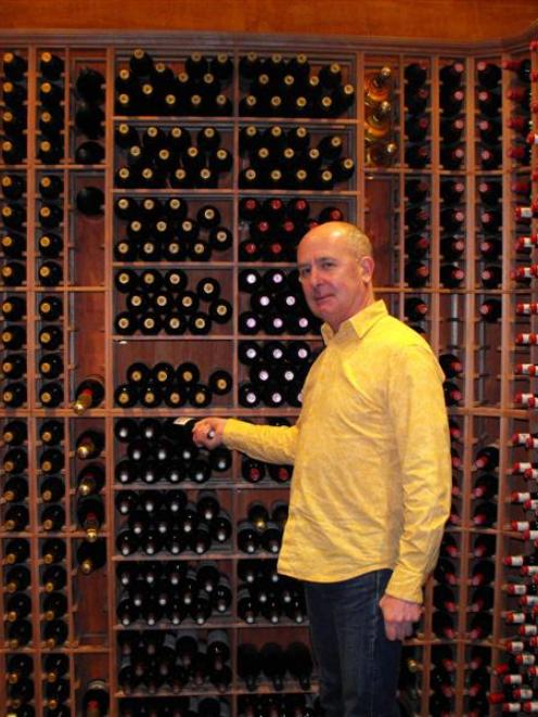 Rees Hotel chief executive Mark Rose holds a $4000 bottle of wine in the award-winning cellar...