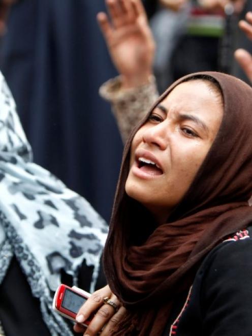 Relatives of Muslim Brotherhood members and supporters of ousted President Mohamed Mursi react...