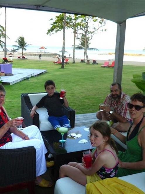 Relaxing at Club Med Bali are (from left) wife Dianne, grandchildren Tamai (8), Billie (10), son...