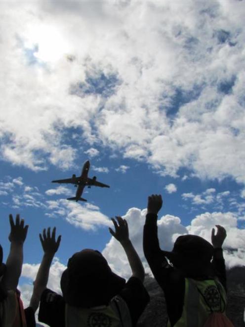 Remarkables Primary School pupils wave goodbye to a jet aircraft at Queenstown Airport yesterday.