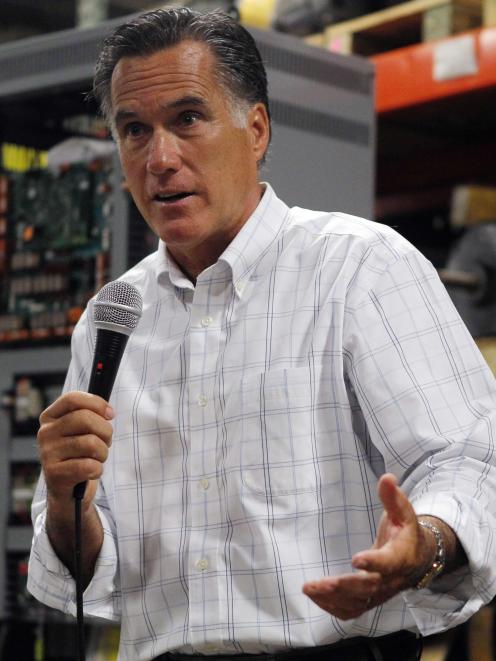 Republican presidential candidate Mitt Romney speaks to employees during a visit to Stanley...