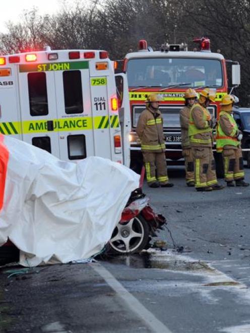 Rescue personnel at the scene of a fatal crash on State Highway 88, about 400m northeast of the...