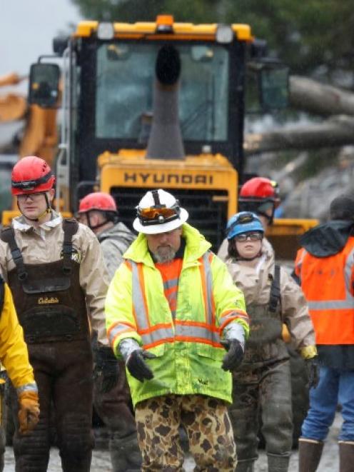 Rescue workers at the scene of the massive mudslide in Oso, Washington. REUTERS/Lindsey Wasson/Pool