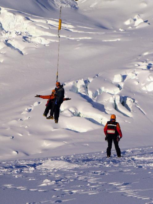 Rescued Australian climber, 42 year old Miles Vinar is brought off Mt Cook by helicopter. Photo...
