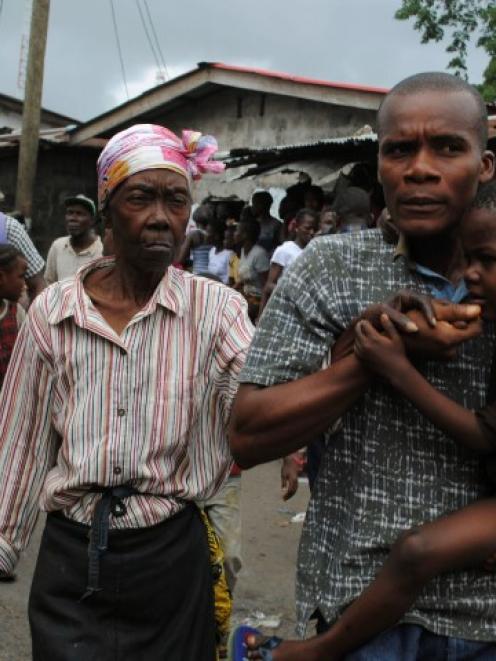 Residents flee during clashes in the West Point quarantined neighbourhood of Liberia's capital...