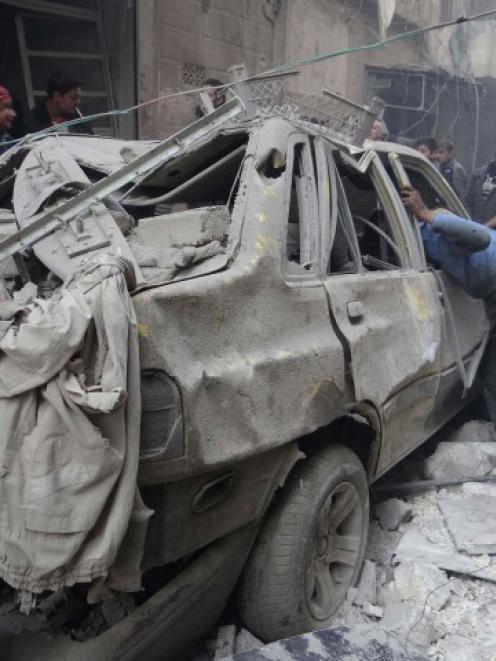 Residents look for survivors after what activists said was an air strike from forces loyal to...