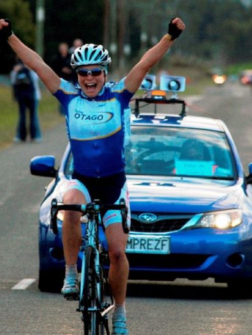 Reta Trotman, of Dunedin, celebrates her victory in the elite women's race at the national club...