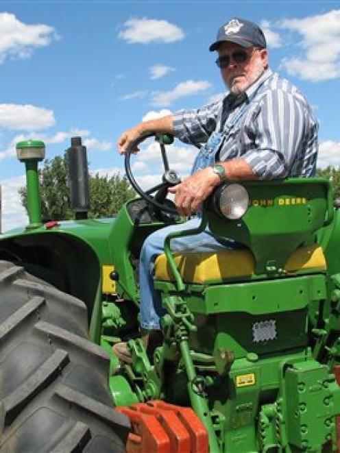 Retired truck driver Bud Grose, 76, sits on his 1959 John Deere tractor yesterday. Photo by AP.