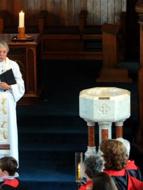 Rev Dr Sarah Mitchell sings the blessing at her last service at Knox Church yesterday. At right...