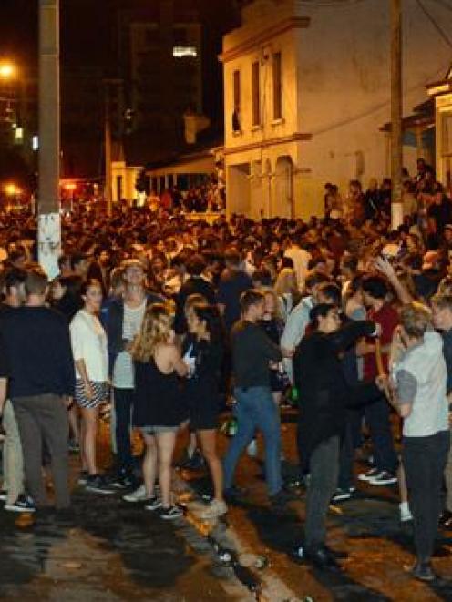 Revellers gather in Hyde St on Saturday night. Photo by Peter McIntosh.
