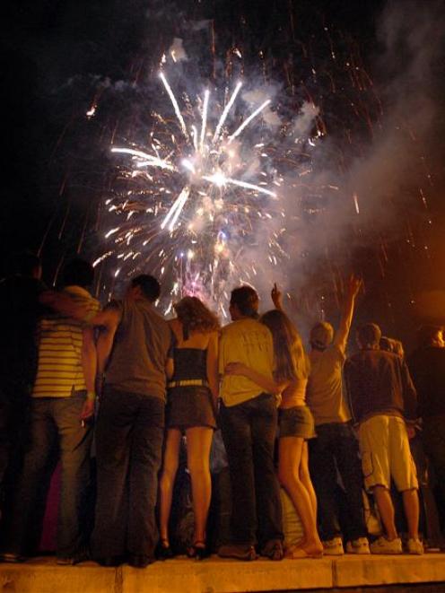 Revellers watch the Queenstown fireworks display which welcomed in 2006. Queenstown's Earnslaw...