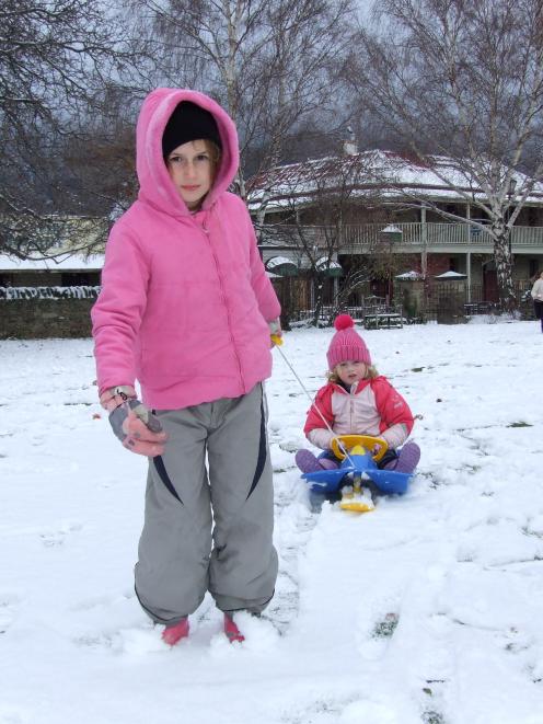 Rhian Sharman (7) and Emily Wellstead (3), both of Clyde, enjoy tobogganing in Clyde yesterday....