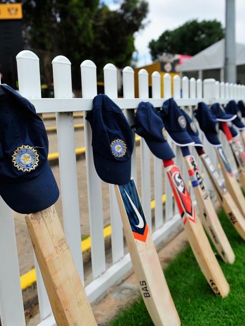 ricket bats and caps are seen layed out by Indian players paying tribute to Phillip Hughes before...