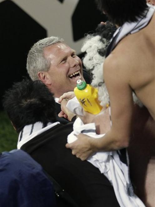 Ricki Herbert celebrates with supporters after the World Cup group F soccer match between Italy...