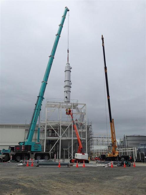 Riggers use a crane to install a biodiesel distillation column at Z Energy’s commercial biodiesel...