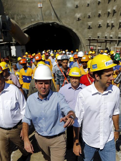 Rio Mayor Eduardo Paes (C) and Governor Luiz Fernando Pezao (2nd L) leave one of the two tunnels...