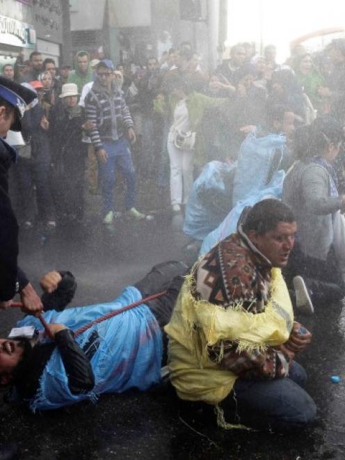 Riot police officers scuffle with the protesters who threatened to set themselves in Rabat....