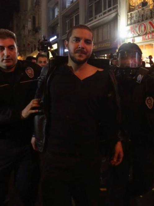 Riot policemen detain a demonstrator during the protest against internet censorship in Istanbul....
