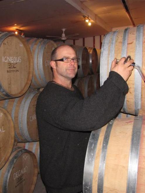 Rippon Vineyard assistant winemaker Brett Reddington takes a sample of the winery's 2013 gamay...