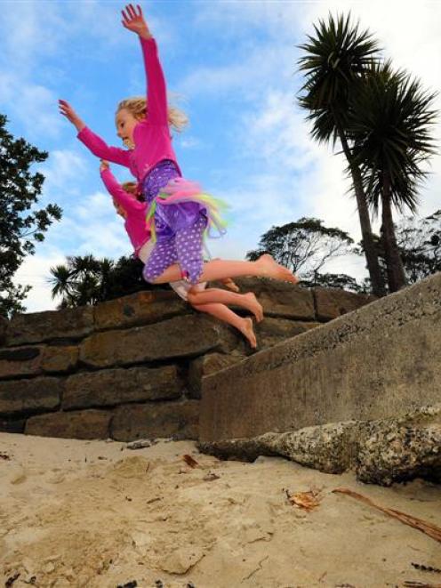 River (5) and Tasman (7) Charteris-Wright jump from steps on to Broad Bay Beach. Photo by Craig...