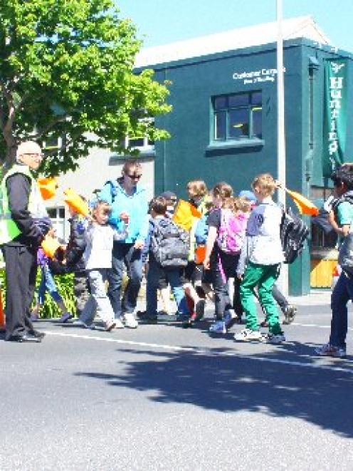 George Street Normal School principal Rod Galloway (left) supervises his pupils as they cross...