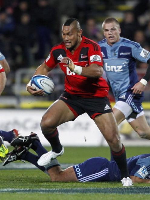 Robbie Fruean of the Crusaders makes a break against the Blues in their match at AMI Stadium in...