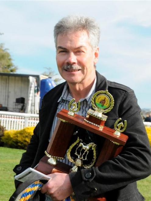 Robert Famularo with the trophy for the Hannon Memorial won by his horse Monkey King at Oamaru...
