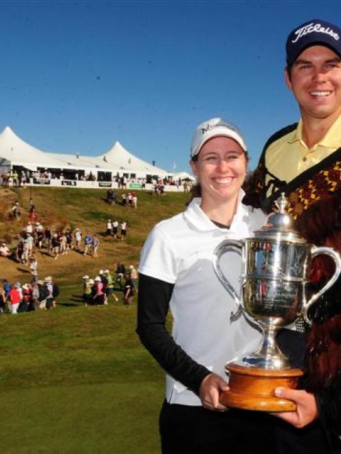 Robert Gates and caddy-girlfriend Lauren Johnson pose with the Brodie Breeze Challenge Cup after...