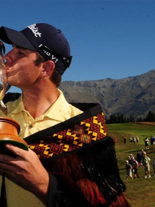 Robert Gates, of the United States, kisses the Brodie Breeze Challenge Cup after winning the...