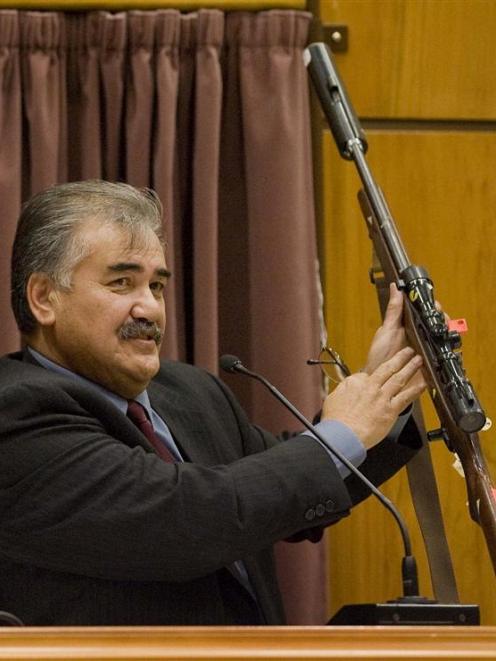 Robert Ngamoki, a police armourer, with the rifle used in the Bain murders, at the David Bain...