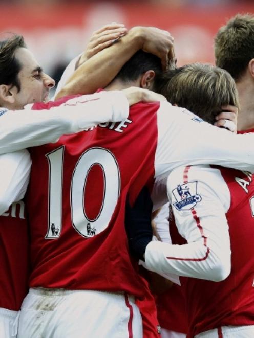 Robin van Persie (10) of Arsenal is congratulated after scoring against Swansea City during their...